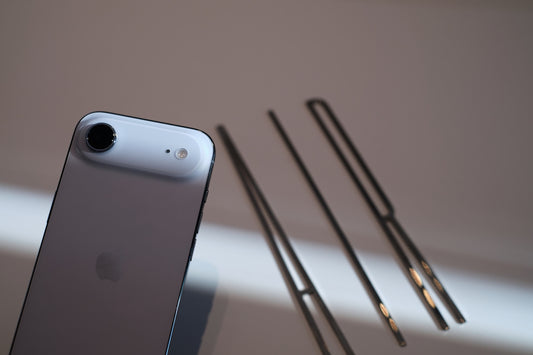 Smartphone and chopsticks on a white surface