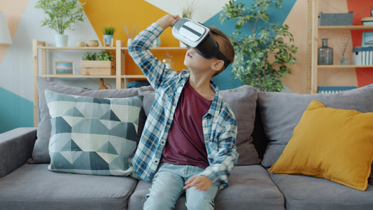 Boy wearing vr headset on a couch.