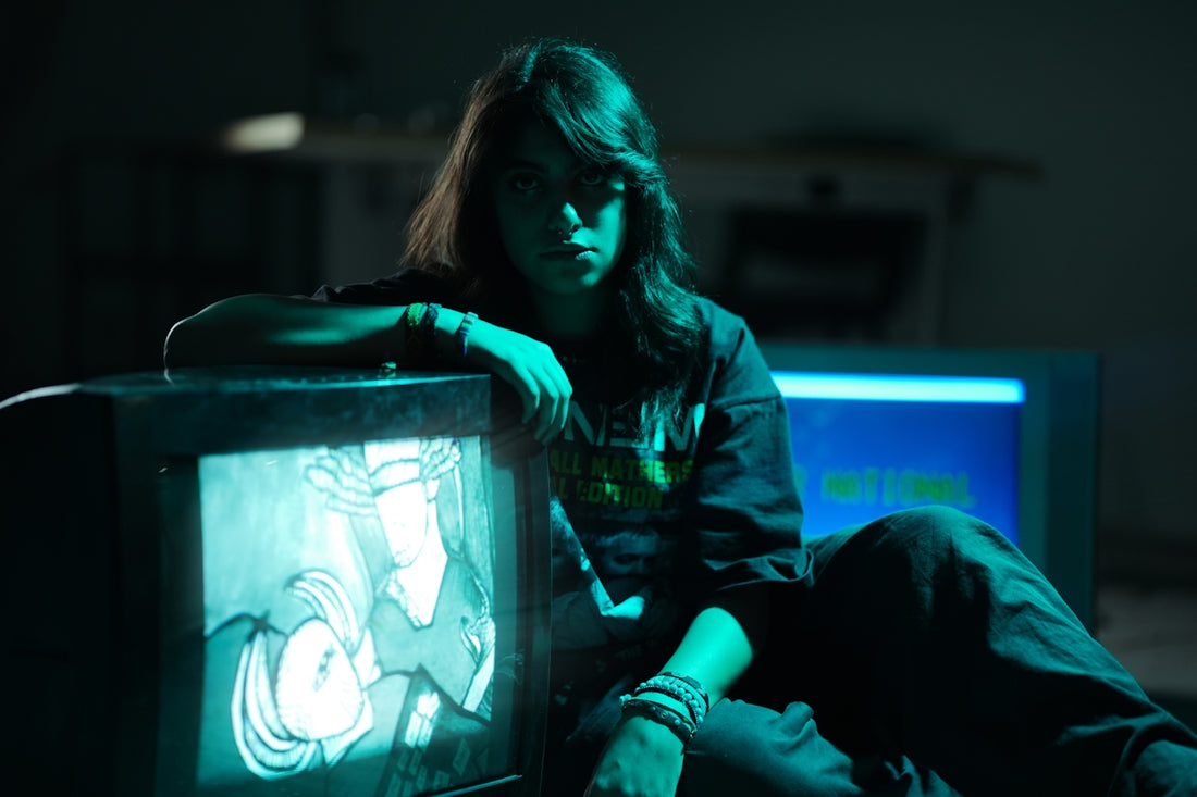 Young woman with long hair by vintage televisions.