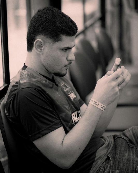 Man looking at his phone on a bus