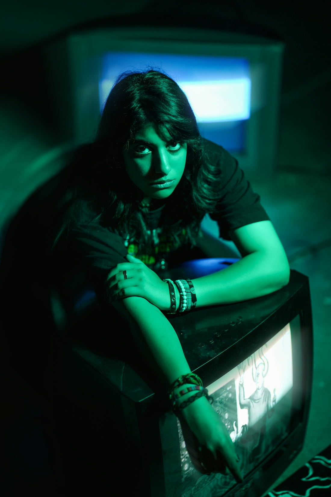 Woman with dark hair leans on old TV