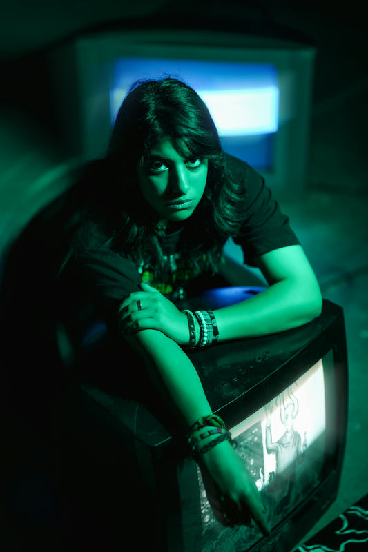 Woman with dark hair leans on old TV