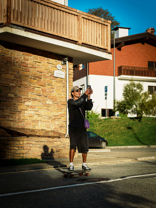 Man on skateboard taking a selfie