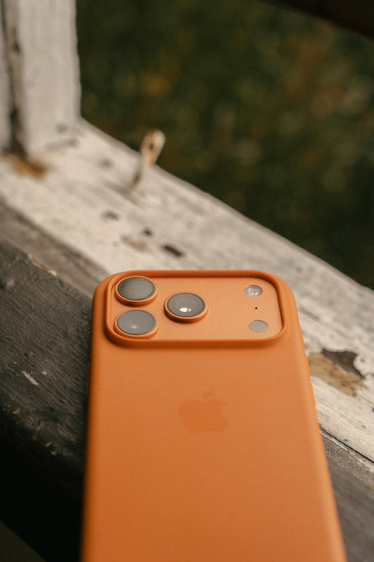 Orange iPhone case with three camera lenses